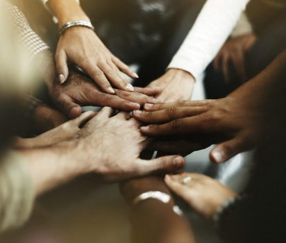 Closeup of diverse people joining their hands